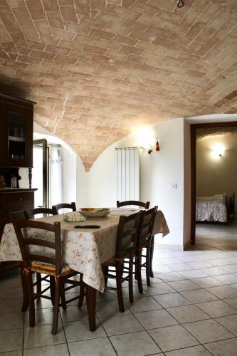 a dining room with a table and some chairs at Via Roma 19 in Castel del Monte