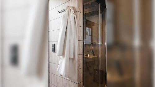 a robe hanging on a wall in a bathroom at Roatel Wörnitz A7 my-roatel-com in Wörnitz