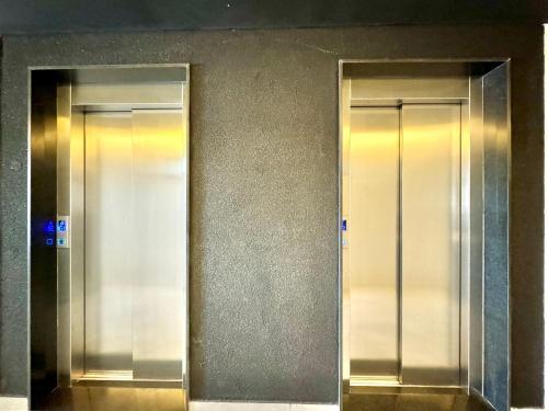 two elevators in a building with their doors open at (1209)Studio com vista panorâmica mar in São Luís