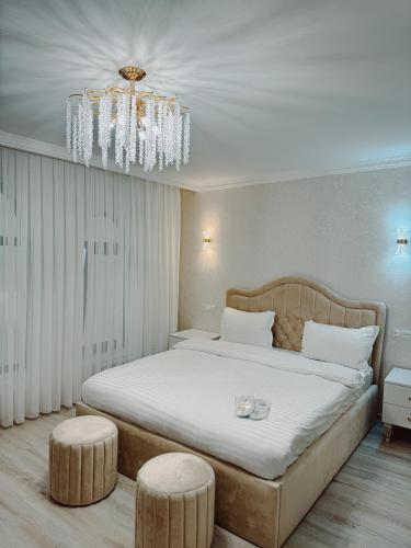 a bedroom with a large bed and a chandelier at Old Yerevan Boutique Hotel in Yerevan
