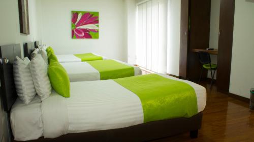Ένα ή περισσότερα κρεβάτια σε δωμάτιο στο Hotel macao colombia