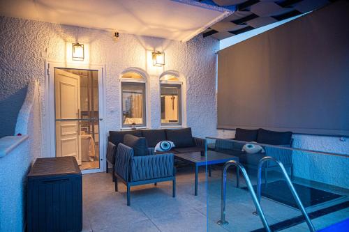 a living room with a couch and a table at NS Villa Kastrosykia in Pídima Kyrás