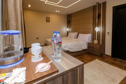 a room with a bed and two bottles of water on a table at Rotana Pyramids View in Cairo