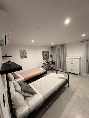 a bedroom with two beds and a desk in it at Apartment in Palmela - Close to Beaches and Mountains! in Palmela