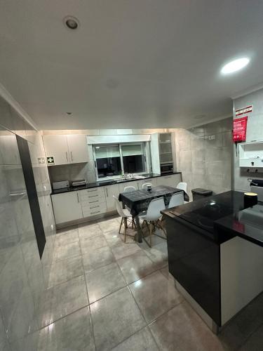 a large kitchen with a table and chairs in it at Apartment in Palmela - Close to Beaches and Mountains! in Palmela