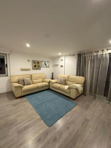 a living room with two couches and a rug at Apartment in Palmela - Close to Beaches and Mountains! in Palmela