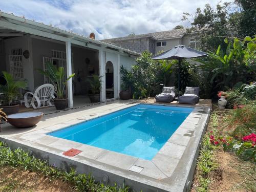 a swimming pool in the backyard of a house at Studio Evalia in Albion
