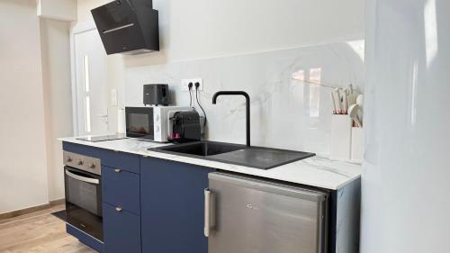 a kitchen with a sink and a stove at COCON Mayennais - Loft Balnéo Laval - Loveroom in Laval