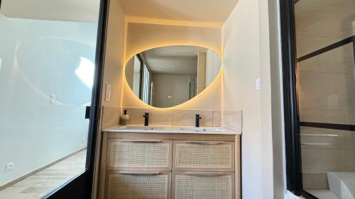 a bathroom with a sink and a mirror at COCON Mayennais - Loft Balnéo Laval - Loveroom in Laval