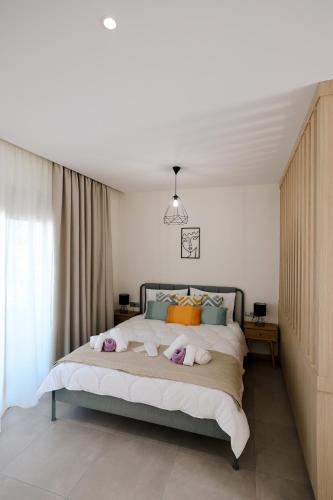 イアリソスにあるOlympian Apartmentsのベッドルーム1室(ベッド1台、動物2匹の詰め物付)
