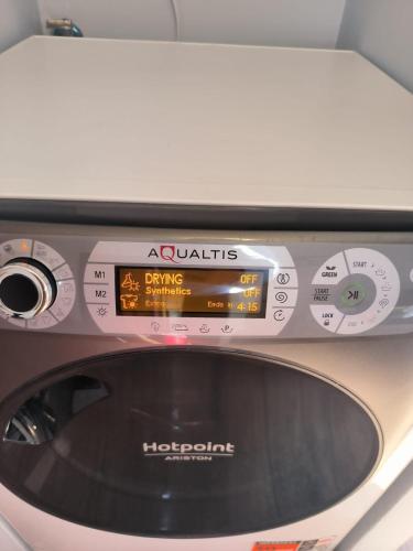 a microwave oven with a digital clock on it at Aurora Boreale studio - centro Aprica - parking in Aprica