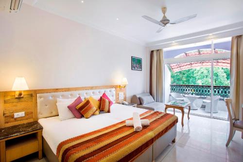 a bedroom with a bed and a large window at Villa San Lawrenz in Lonavala