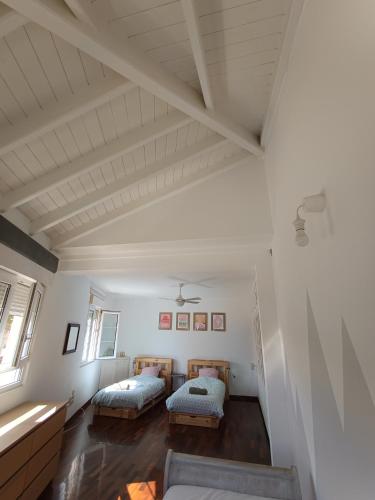 an attic room with two beds and a window at Casa La Vuelta in Águilas