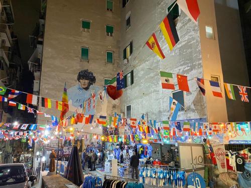 a market in a city with flags and a building at Incoming Quartieri Spagnoli in Naples