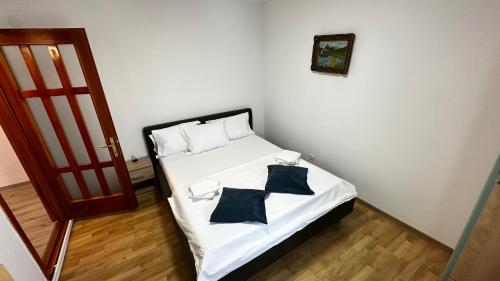 a bedroom with a bed with two pillows on it at DanubeView Apartment Tulcea in Tulcea