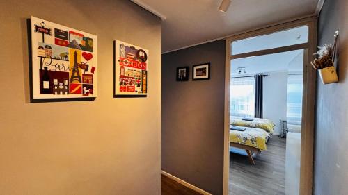 a bedroom with a bed and posters on the wall at Top Floor of the building, spectacular views! in Glasgow