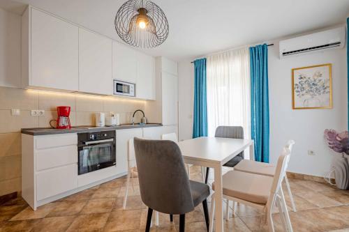 a kitchen and dining room with a table and chairs at Vacation home in Budva with fantastic oceanview in Krimovice