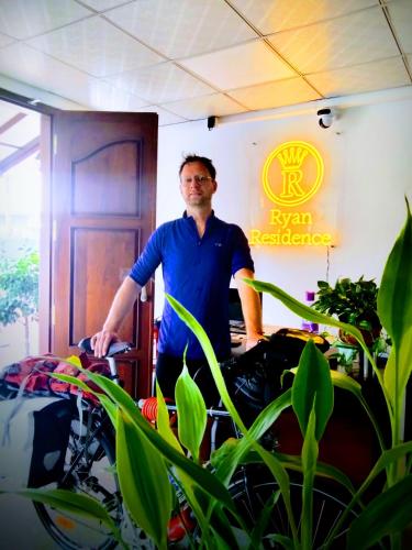 a man standing in a room with some plants at Ryan Residence & Restaurant in Negombo