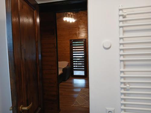 a hallway leading to a room with a bed at Popa Cabana in Sibiu