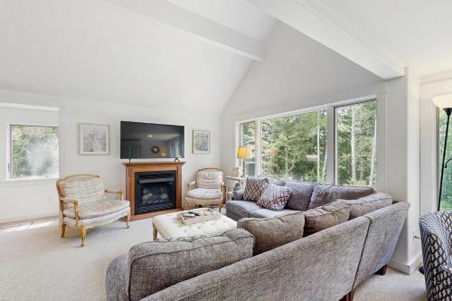 a living room with a couch and a fireplace at Fairy Cottage in the Wood in Bartlett