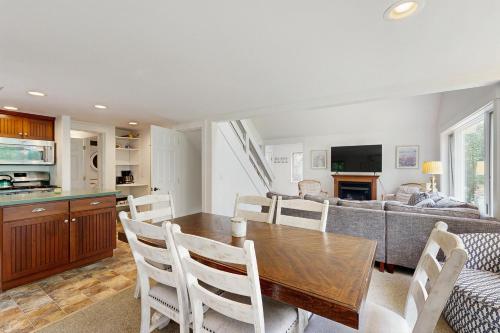 a kitchen and living room with a table and a couch at Fairy Cottage in the Wood in Bartlett