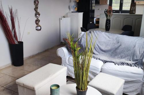 a living room with a white couch and a table at Georgia's Dream House in Koprána