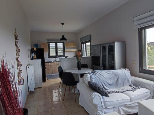 a living room with a white couch and a table at Georgia's Dream House in Koprána