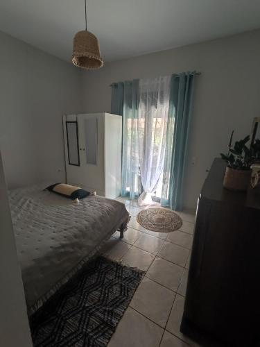 a bedroom with a bed and a large window at Georgia's Dream House in Koprána