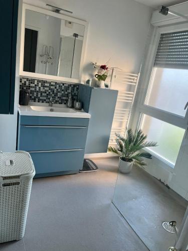 a bathroom with a sink and a mirror at Douce Escapade Sud 7 pers Wi-Fi parking gratuit in Grabels