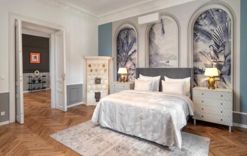 a bedroom with a bed and two night stands with lamps at River Dance Suites by Adrez in Prague