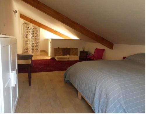 a bedroom with a bed and a desk in a room at La Férandie in Chéronnac