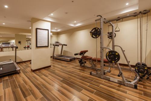 a gym with two treadmills and two exercise bikes at Cozy Savvy Hoi An - The Quintessence of Exquisite Retreat in Hoi An