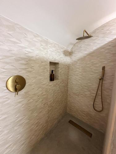 a bathroom with a shower with a sink at Casas do Largo- Amor é Cego in Estremoz