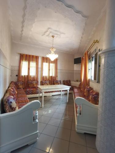 a living room with a table and couches at Family Time in Nador
