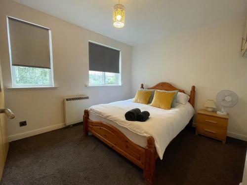 a bedroom with a large bed with two windows at Surrey Docks London near Canada Water Easy Access to Canary Wharf Pier in London