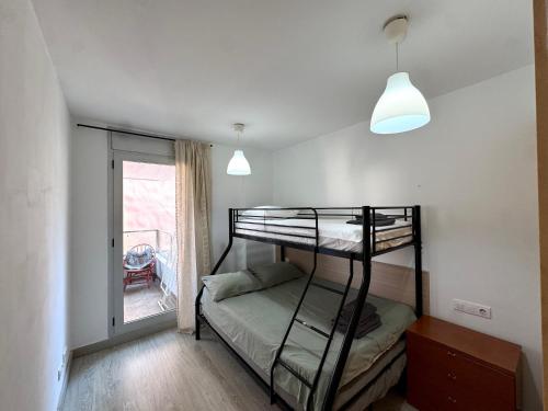 En eller flere senge i et værelse på Santa Clotilde Family Apartment