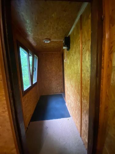 an empty room with a window in a house at Hotel Duga in Novi Sad
