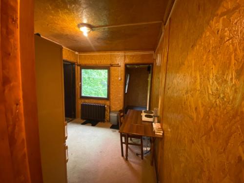 an empty room with a table and a window at Hotel Duga in Novi Sad