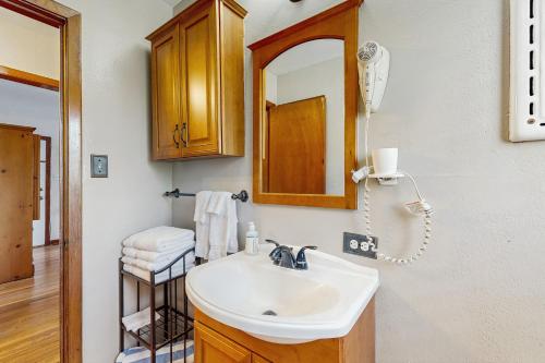a bathroom with a sink and a mirror at Backyard Escape in Galveston