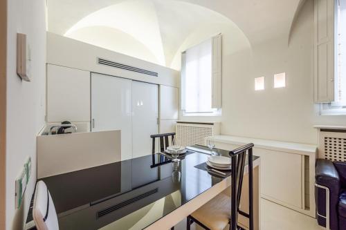 a kitchen with a table and some chairs at Mini-loft just steps from the Duomo of Modena in Modena