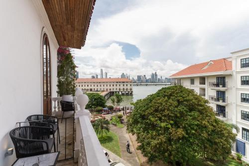 a balcony with a view of the river and buildings at Hotel Bardot Boutique in Panama City