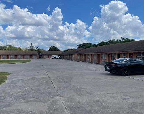 a car parked in a parking lot in front of a building at Lakeside inn & suites by OYO Mathis I 37 in Mathis