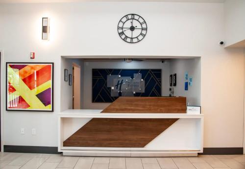 a display case in a room with a clock on the wall at Holiday Inn Express Tucson-Airport by IHG in Tucson