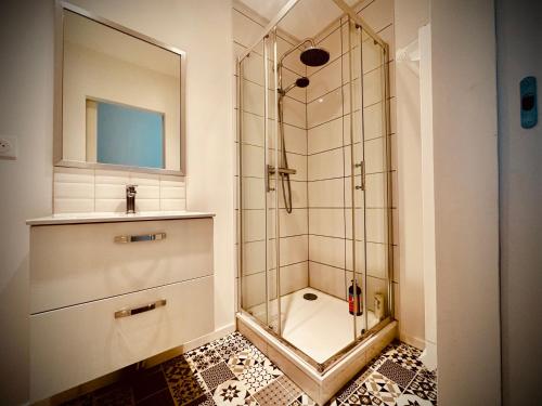 a bathroom with a shower and a sink at Poule Noire Ukraine in Égreville