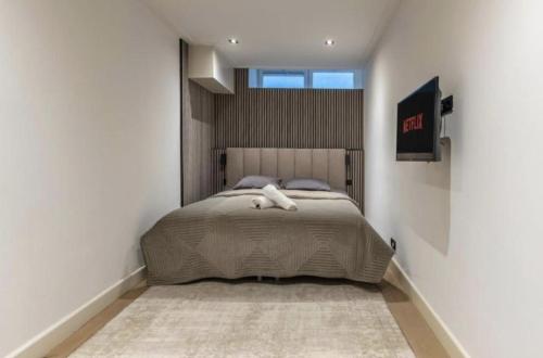 a bedroom with a large bed in a white room at Charming Stay De Pijp at Centrum in Amsterdam