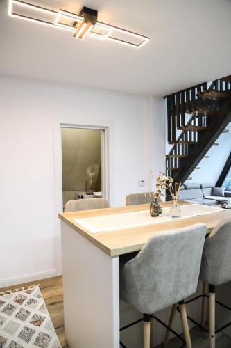 a kitchen with a table and chairs and a staircase at Chalet Palma in Ciumîrna