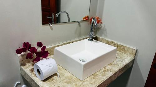 a white sink in a bathroom with a mirror at Pousada Maria do Lampião Jericoacoara- Antigo Jeri Vila Mini in Jericoacoara
