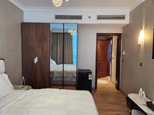 a hotel room with a bed and a mirror at Maadi Urban Apartment in Cairo