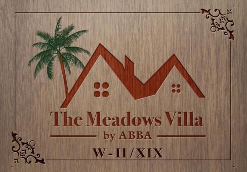a sign for the meadows villa with a palm tree at The Meadows Villa by ABBA in Rānī