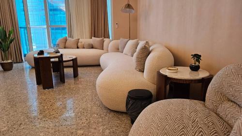 a living room with a large couch and tables at Maadi Urban Apartment in Cairo